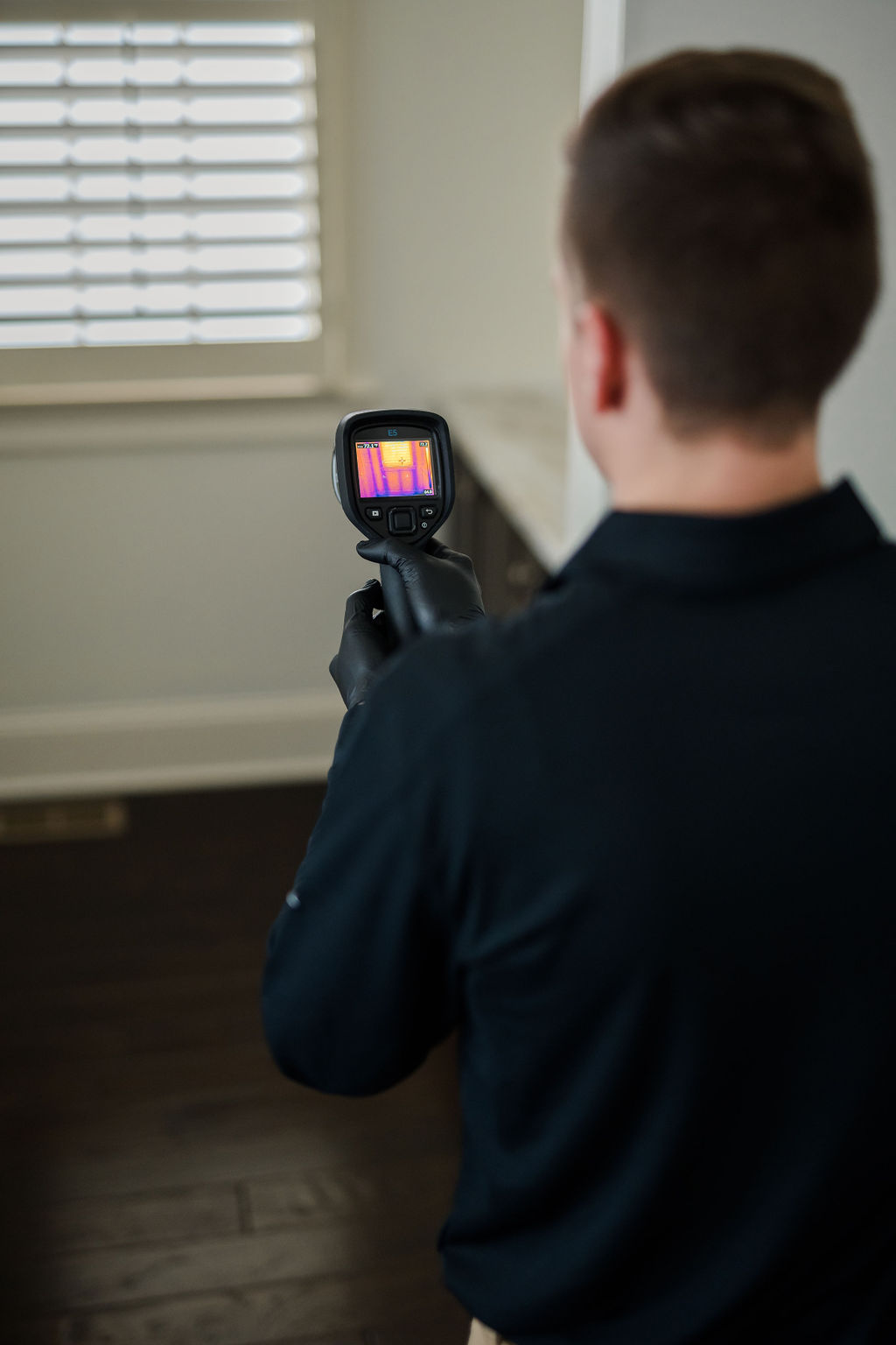 Pest professional examines family room